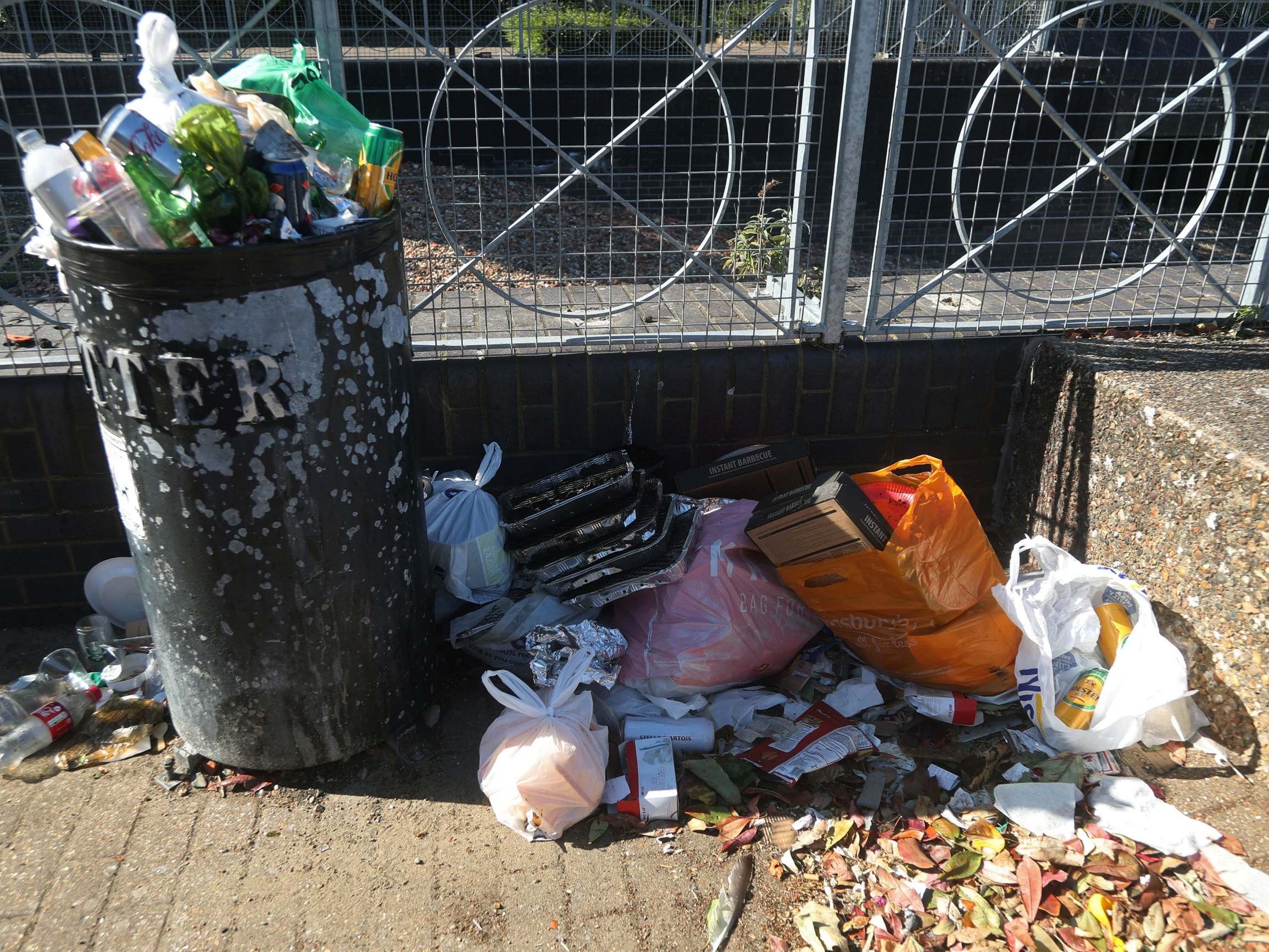 A pile of used disposable barbecues next to a litter bin on the Isle of Dogs, London, after the introduction of measures to bring the country out of lockdown.