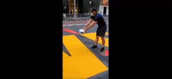 A man vadalises the Black Lives Matter mural outside of Trump Tower in New York City.