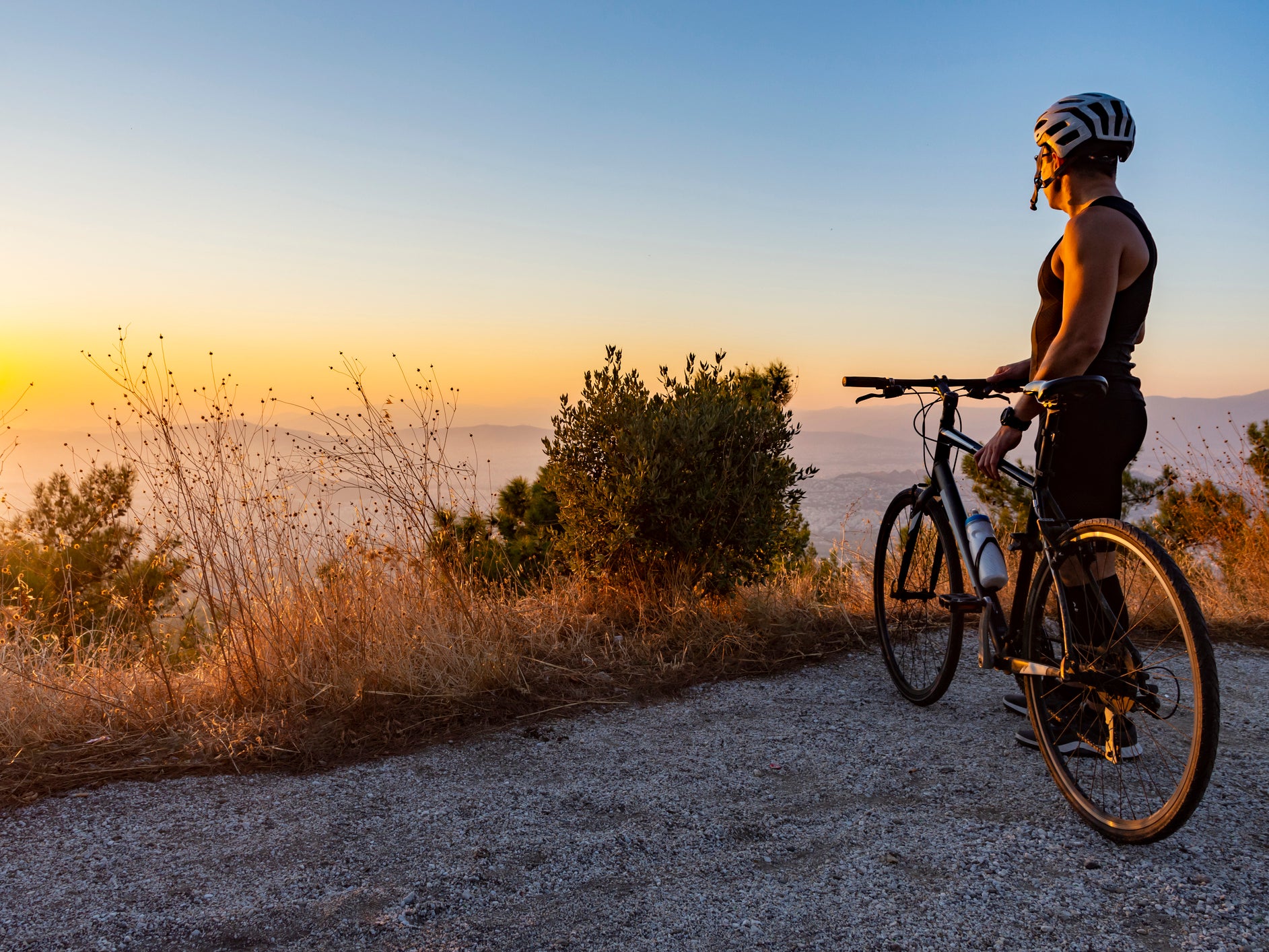 A cyclist watches the sun set in Greece