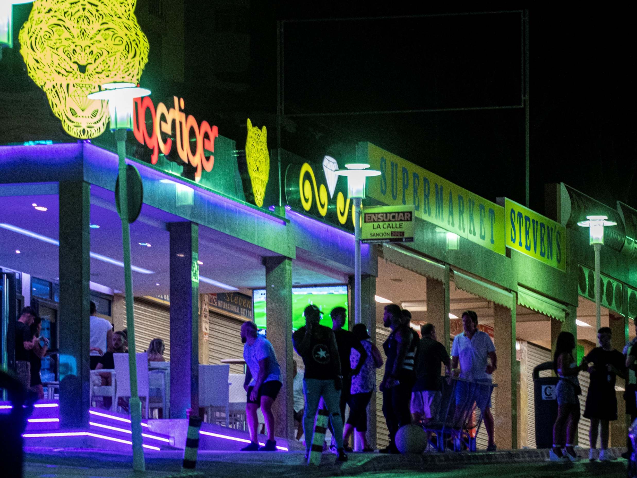 People queue at a pub of Punta Ballena area in Magaluf