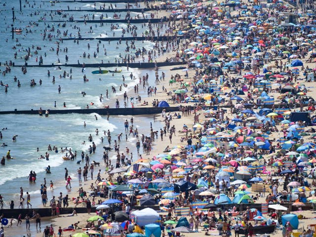 Visitors crowd together as they enjoy the hot weather on the beach on 25 June, 2020 in Bournemouth