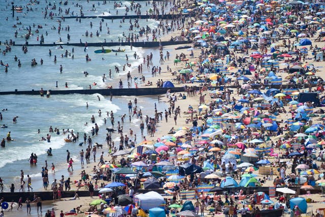 Visitors crowd together as they enjoy the hot weather on the beach on 25 June, 2020 in Bournemouth