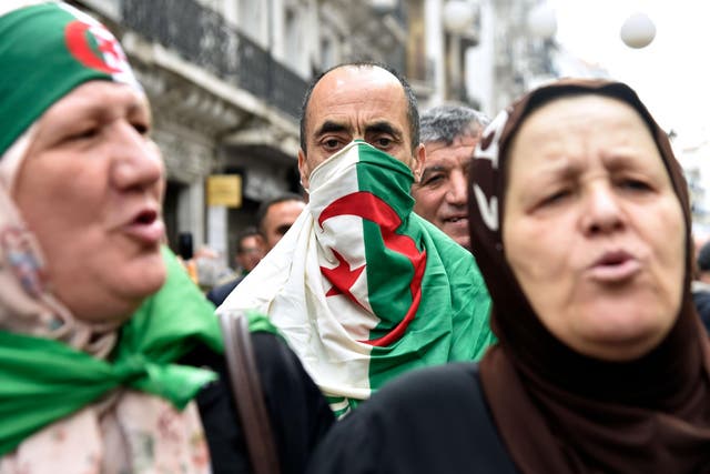 People chant slogans during a weekly anti-government demonstration in the capital Algiers