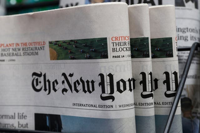 Copies of the New York Times are seen on sale at a news stand in Hong Kong on Wednesday. The paper said it would transfer some of its staff out of the city because of the uncertainties around the new national security law