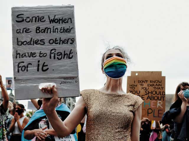 A demonstrator holds up a placard at a Trans Rights protest in London