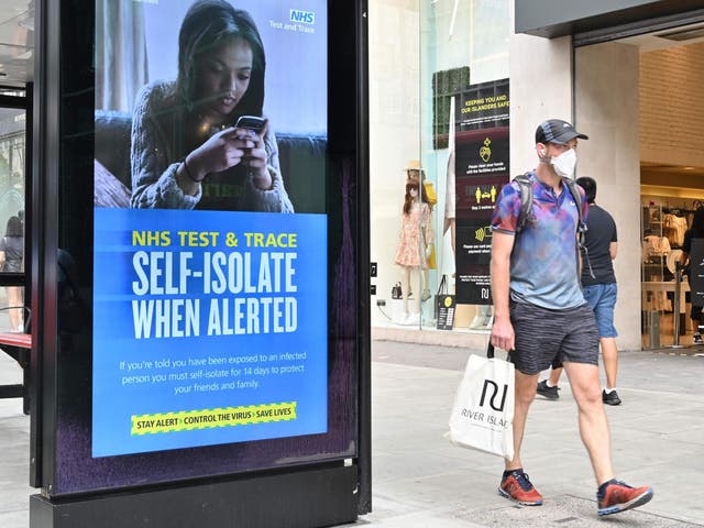 A shopper walks past an advertisment for the UK government's NHS Test and Trace system in Regent Street in London