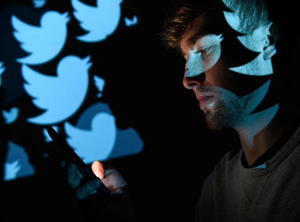In this photo illustration, the logo for the Twitter social media network is projected onto a man on August 09, 2017 in London, England