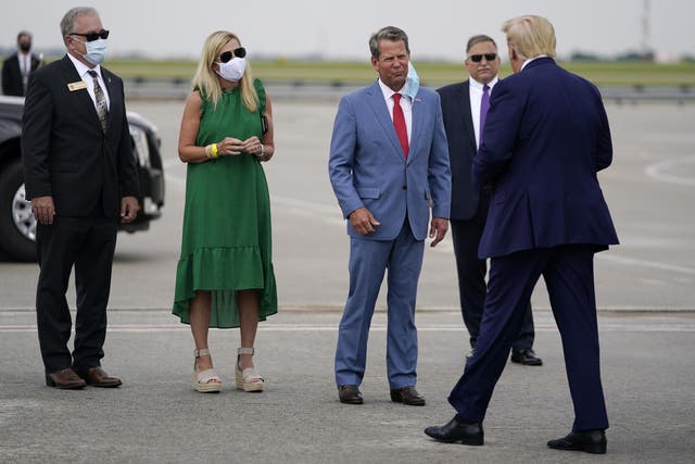 Georgia Governor Brian Kemp, third from left, greets President Donald arrives at Hartsfield-Jackson International Airport on 15 July, 2020