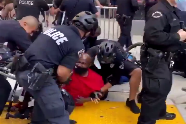 The police detain a man in a wheelchair at a Black Lives Matter protest in California
