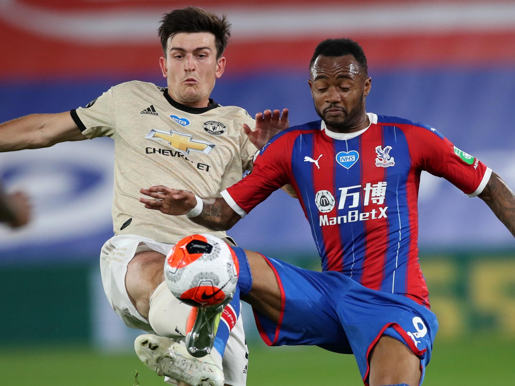 United captain Harry Maguire vies for the ball with Palace’s Jordan Ayew