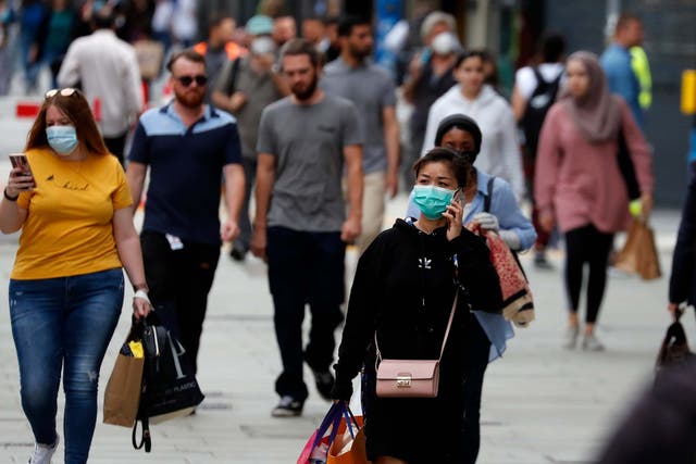 Customers wear masks as they shop at Primark in Oxford Street