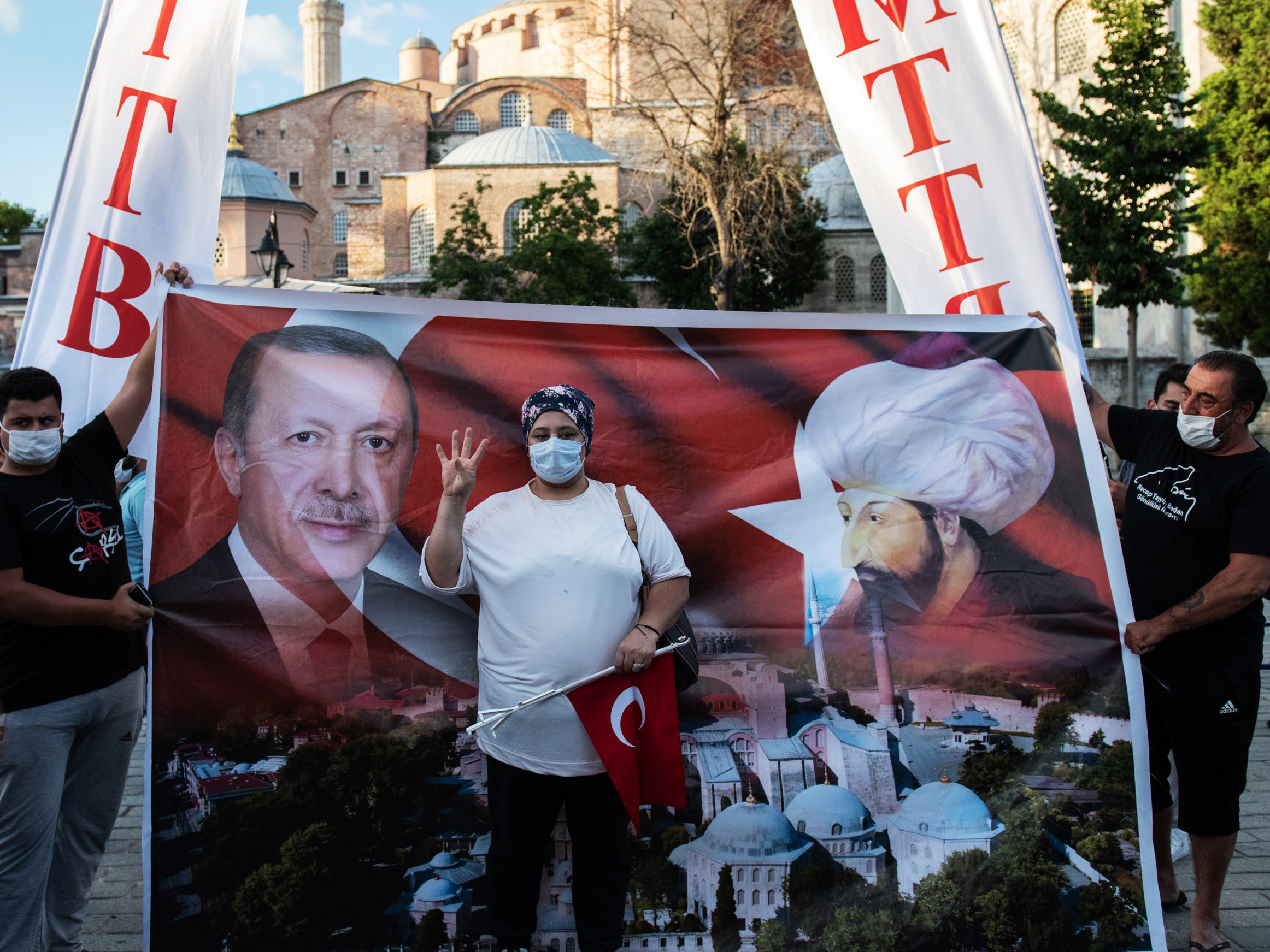 A flag depicting Erdogan alongside Ottoman sultan Mehmed II outside Hagia Sophia after the cathedral’s museum status was annulled