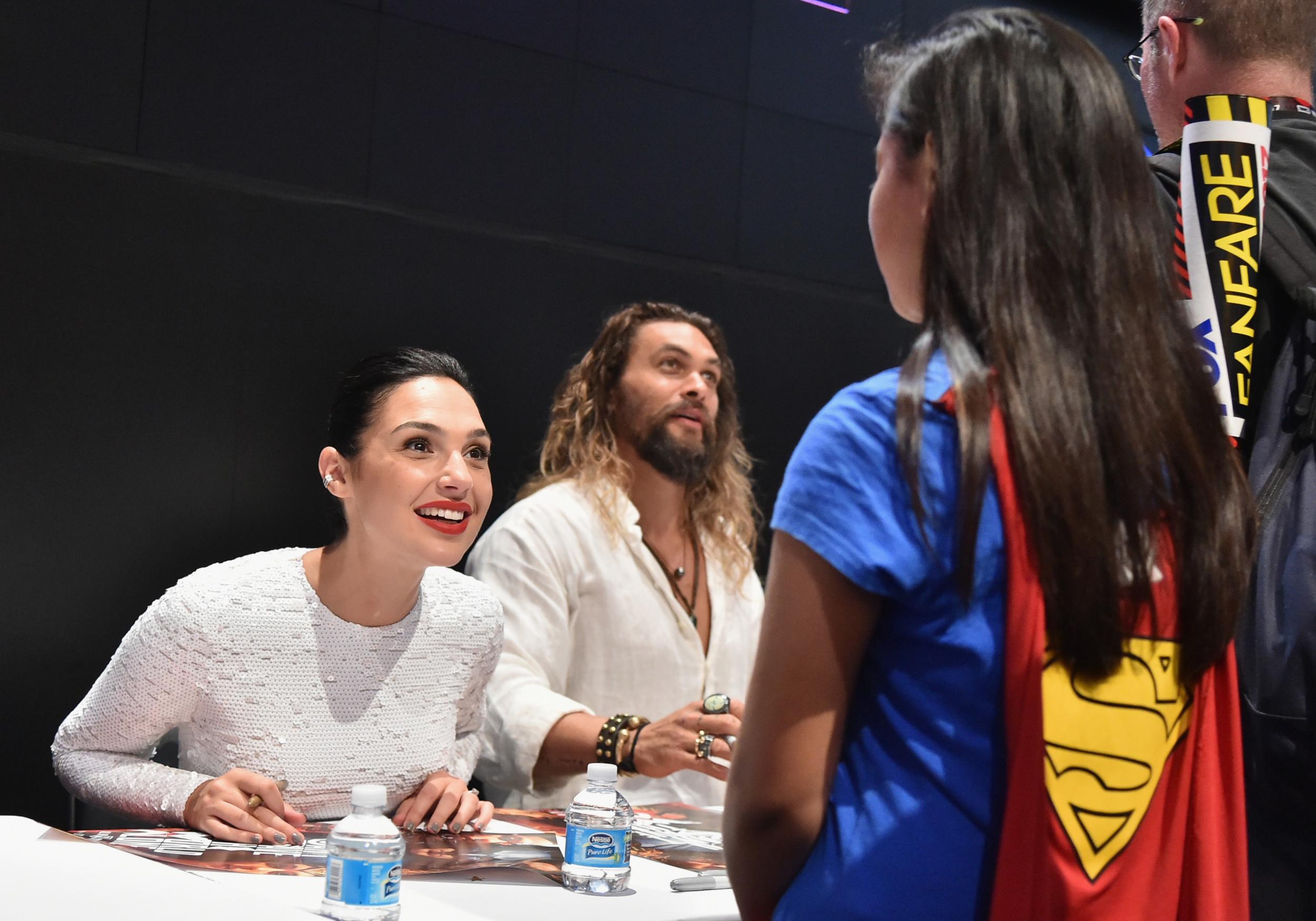 Gal Gadot meets a young Wonder Woman fan during a Justice League cast signing