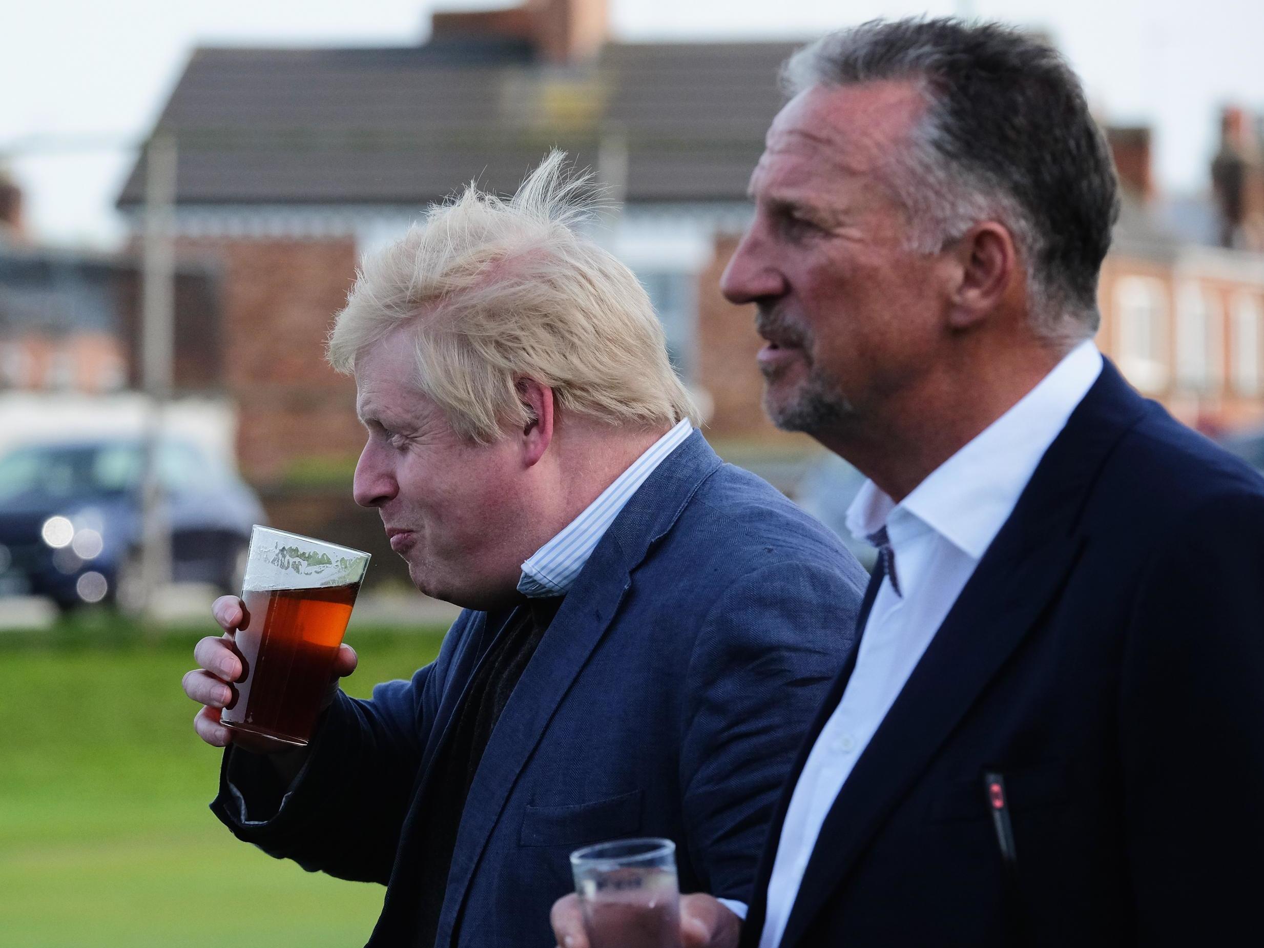 The ex-cricketer enjoys a pint with Boris Johnson during a Vote Leave campaign visit to Chester-Le-Street in May 2016