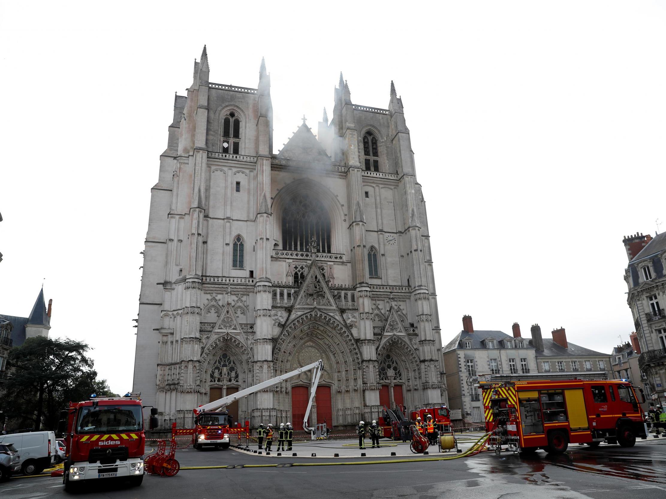 French firefighters gather at the scene of a blaze at the Cathedral of Saint Pierre and Saint Paul in Nantes on Saturday (REUTERS/Stephane Mahe)