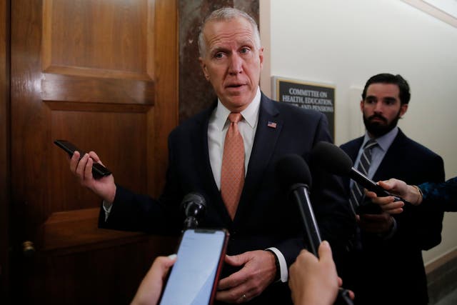 In this 12 March 2020 file photo, Senator Thom Tillis pauses to speak to media on Capitol Hill in Washington