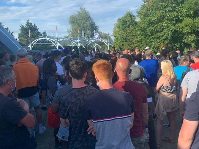 A crowd of people gathering at Thorpe Park in Surrey after reports of a police incident on Saturday evening