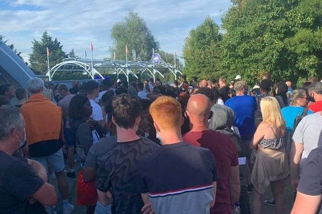 A crowd of people gathering at Thorpe Park in Surrey after reports of a police incident on Saturday evening