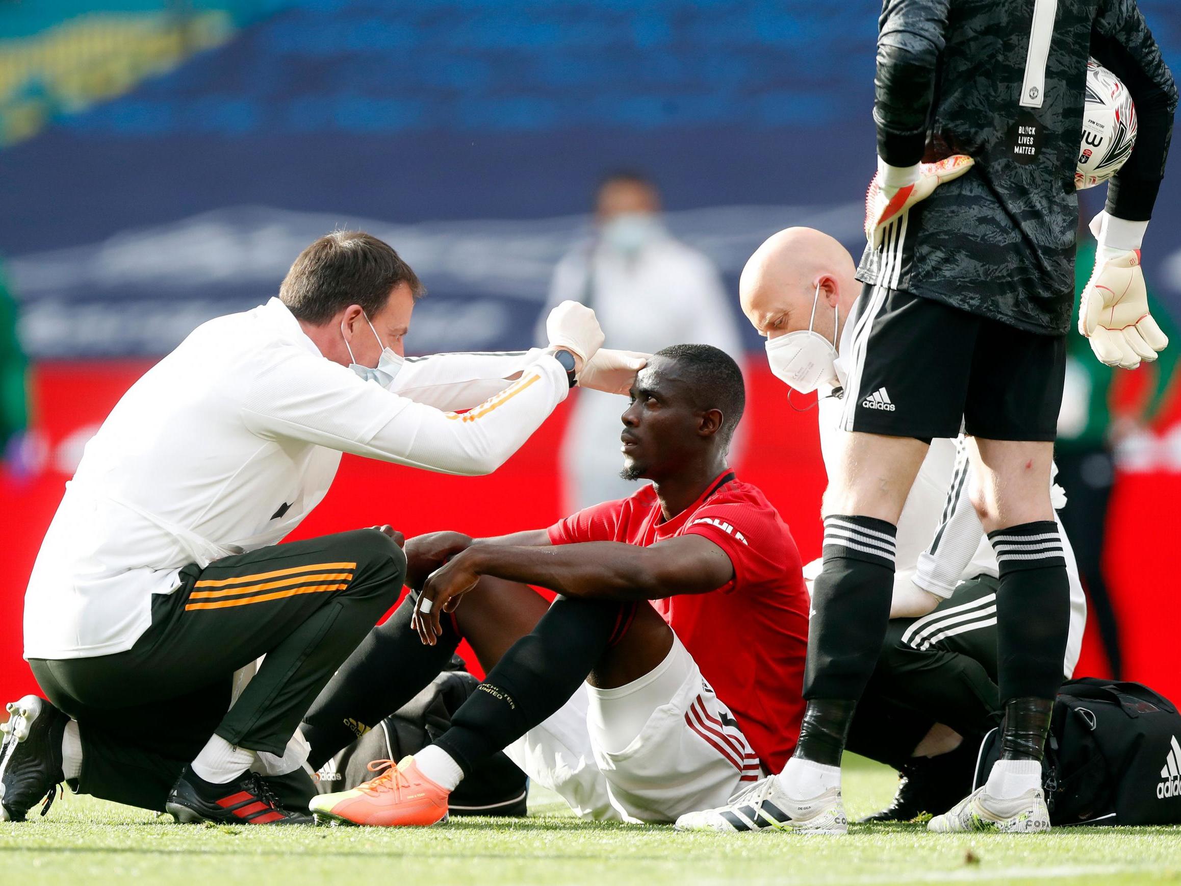 Bailly is attended to after suffering a heavy blow