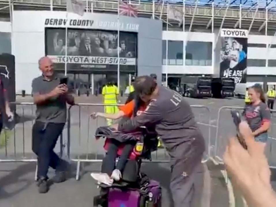 Bielsa hugs a disabled fan outside Pride Park before Leeds's victory over Derby