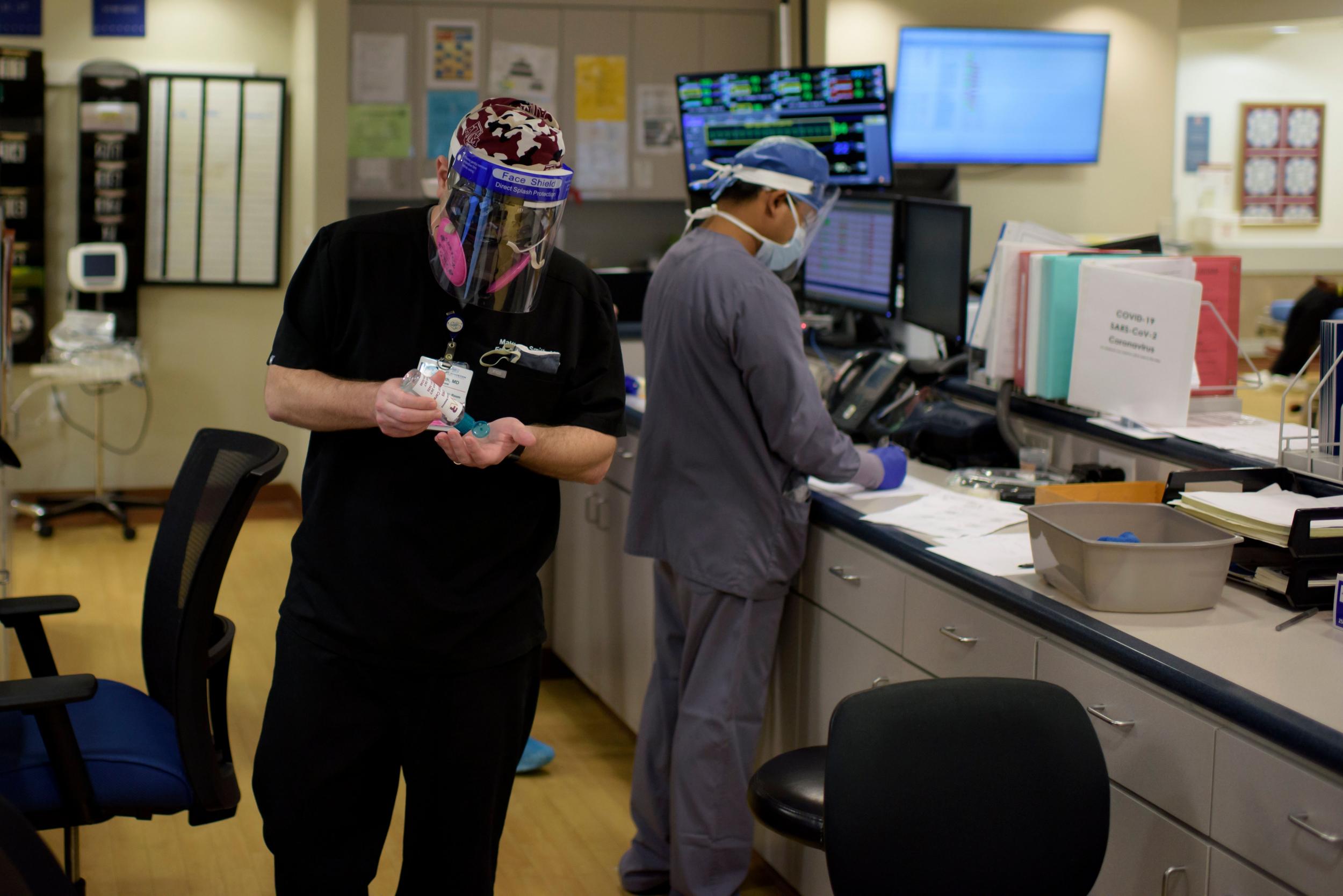 A doctor puts on hand sanitizer in the ER at Oakbend Medical Center in Richmond, Texas, on 15 July, 2020