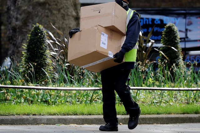 A Hermes delivery courier carries boxes as he makes a delivery to Downing Street
