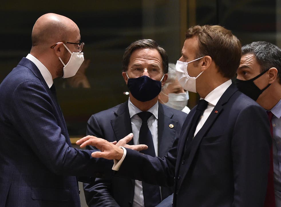 European Council president Charles Michel (left) speaks with Emmanuel Macron (right) and Dutch prime minister Mark Rutte