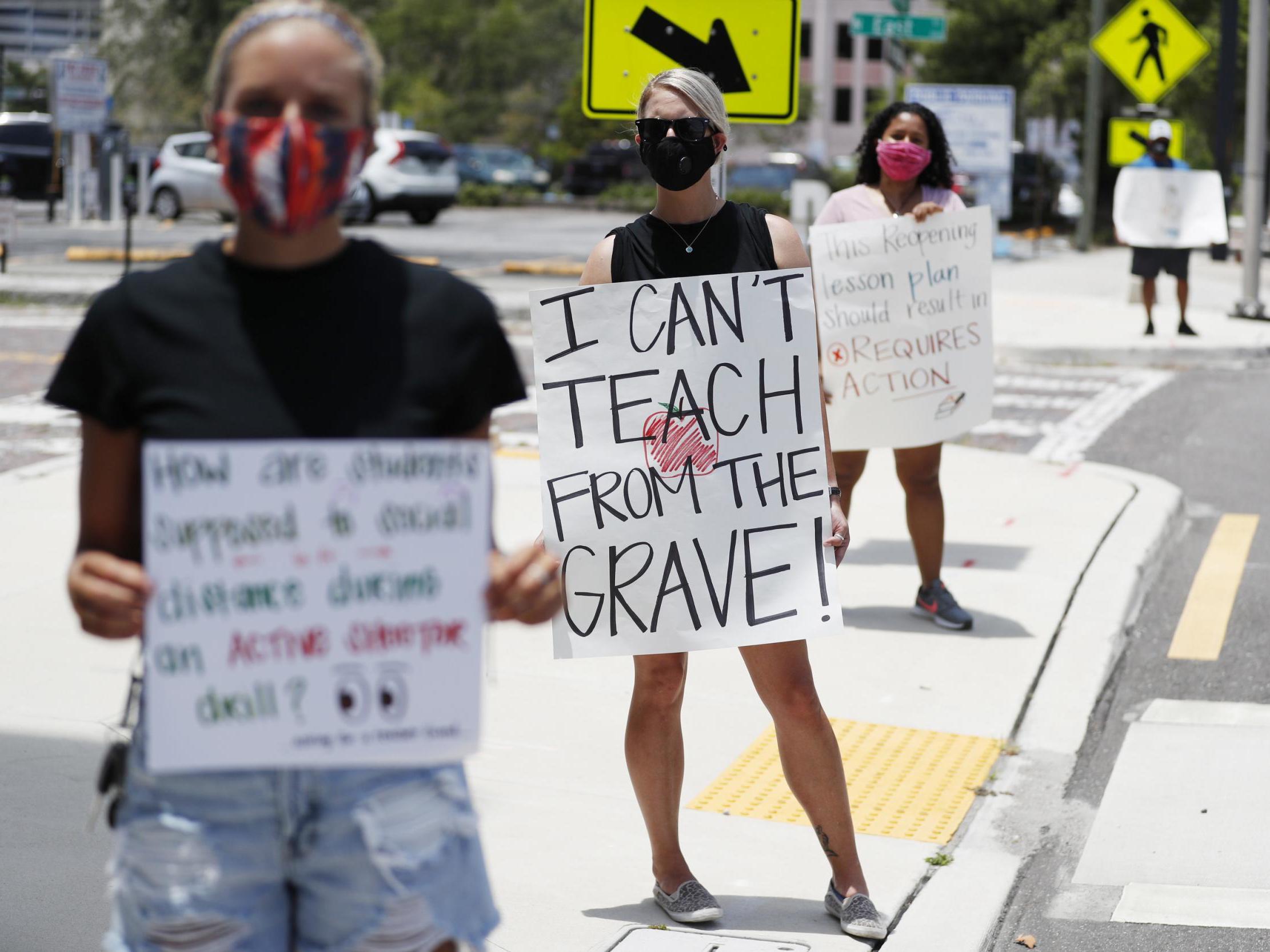 Middle school teacher Brittany Myers (centre) stands in protest in front of the Hillsborough County Schools District Office in Tampa, Florida, where teachers and administrators are rallying against the reopening of schools