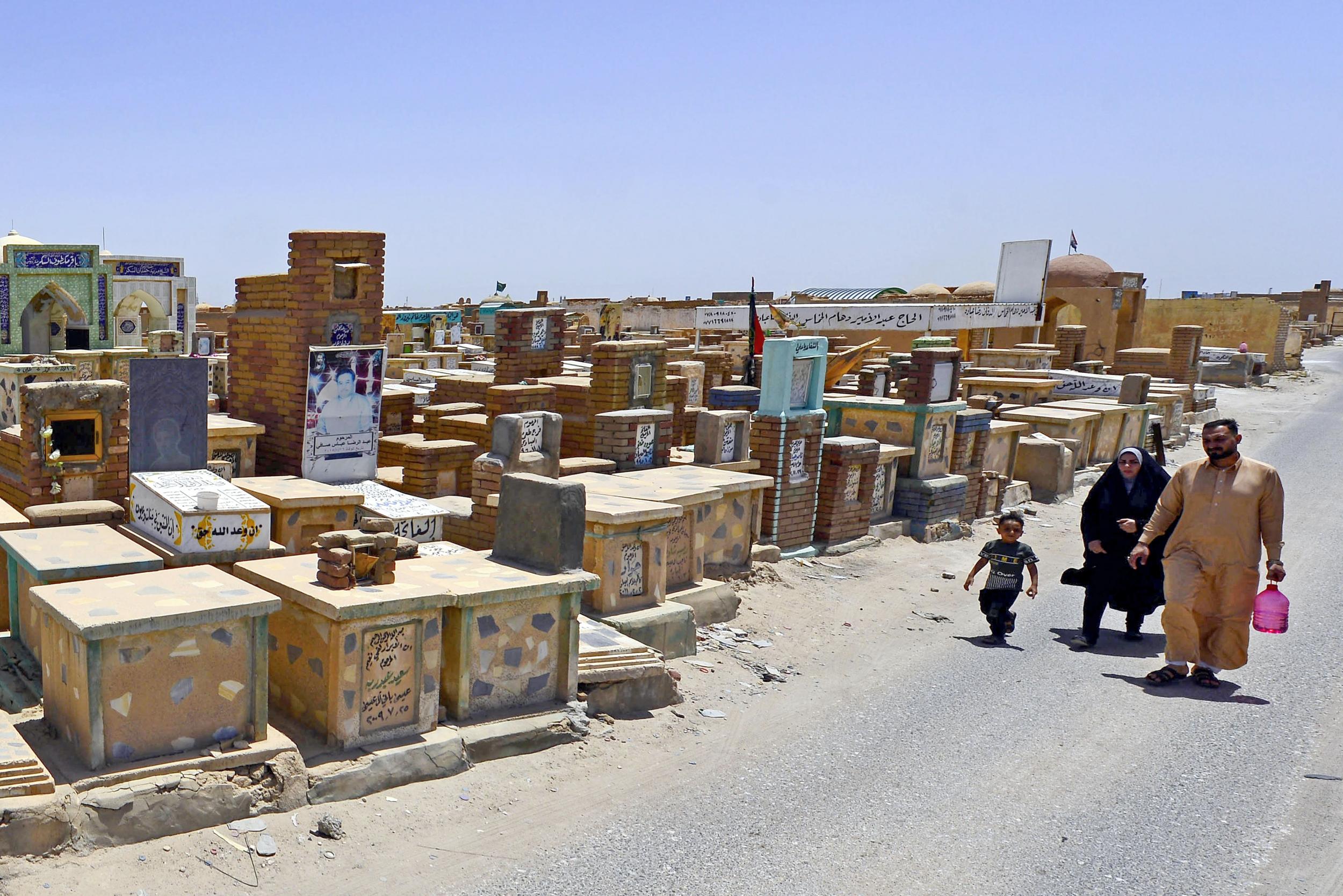 Shia muslims visit the graves of their relatives at the Valley of Peace cemetery on the first day of the Eid al-Fitr holiday on 25 May (AFP/Getty)