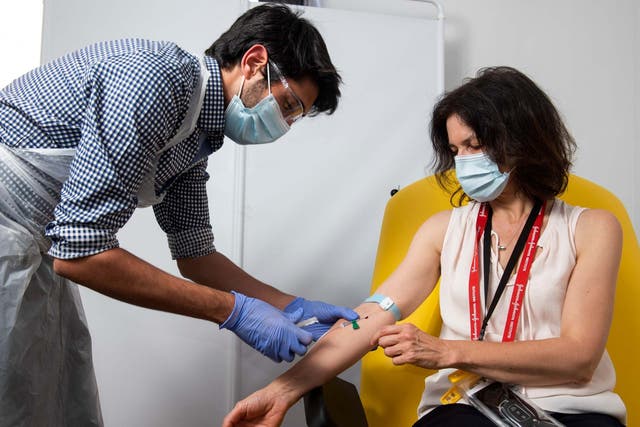 A doctor takes blood samples for use in a University of Oxford coronavirus vaccine trial.