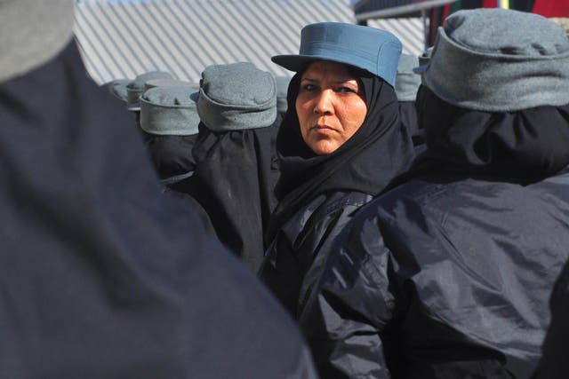 An Afghan police officer stands in formation during a graduation ceremony at a police training centre in Herat
