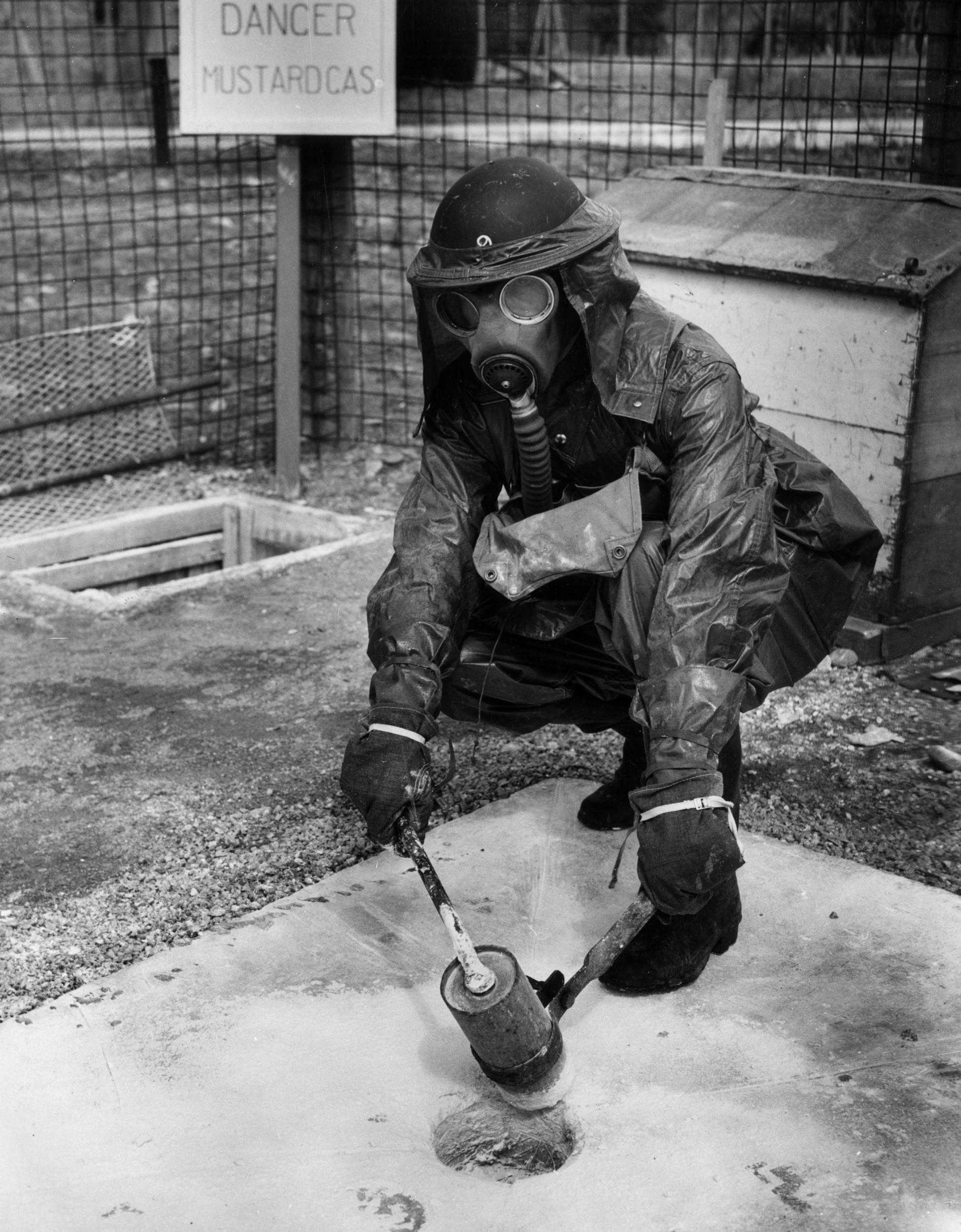 A student at Scotland’s Civil Defence Training School opens a steel bottle containing mustard gas