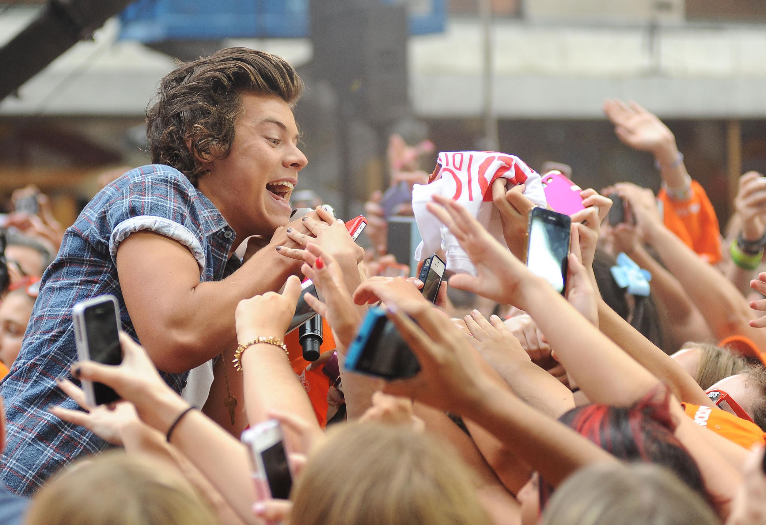 Harry Styles surrounded by a sea of fans at a live show in the US