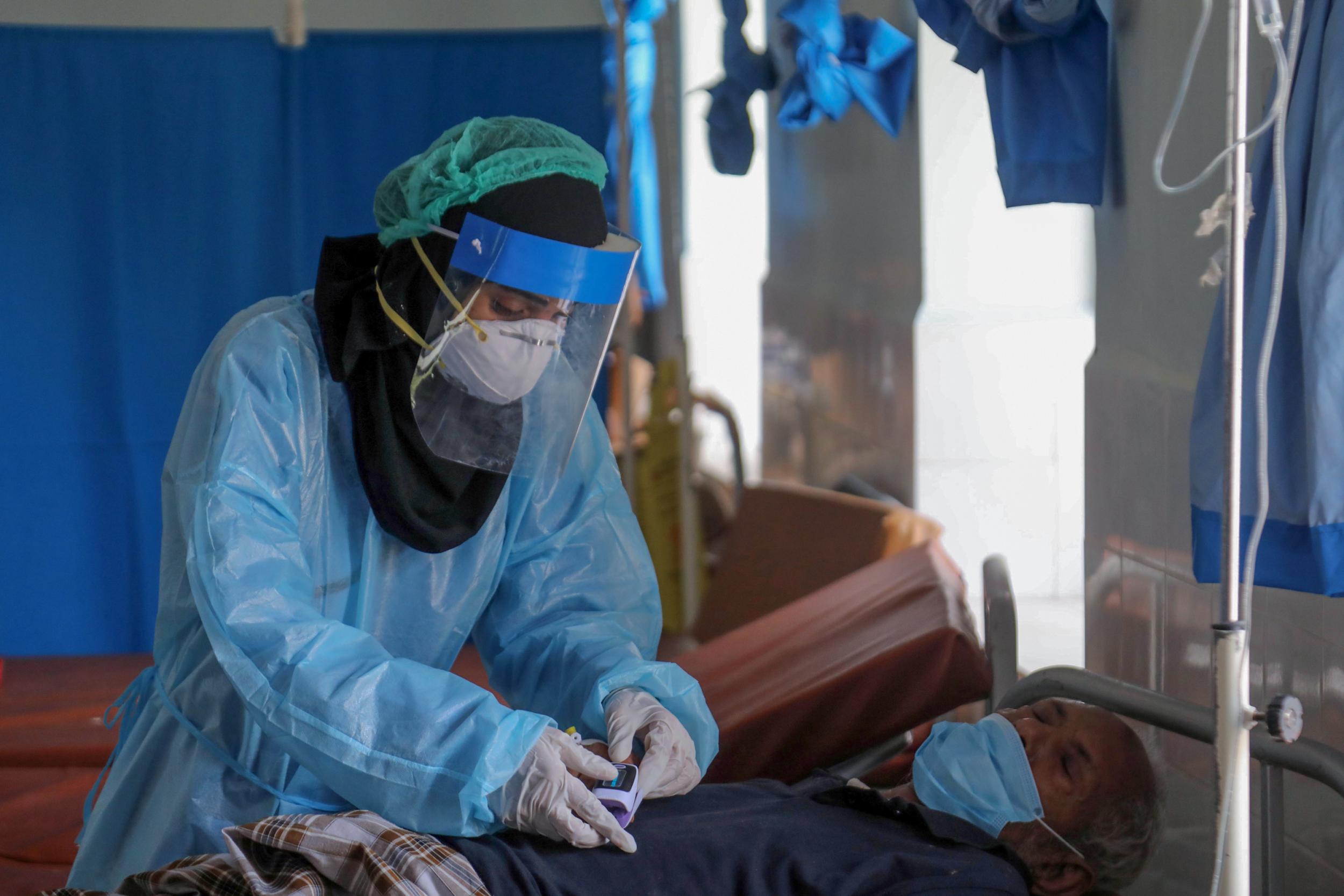 A Yemeni doctor in treats a virus patient at a quarantine centre in Taez