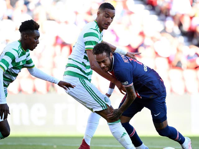 Neymar is challenged by Celtic players during a friendly at the Parc des Princes