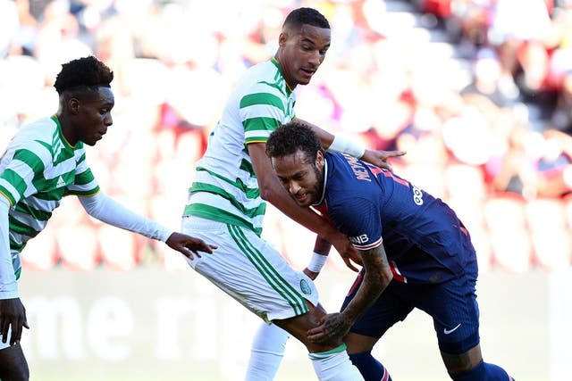 Neymar is challenged by Celtic players during a friendly at the Parc des Princes