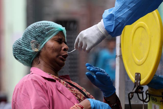 Health worker collects swab samples for coronavirus in New Delhi