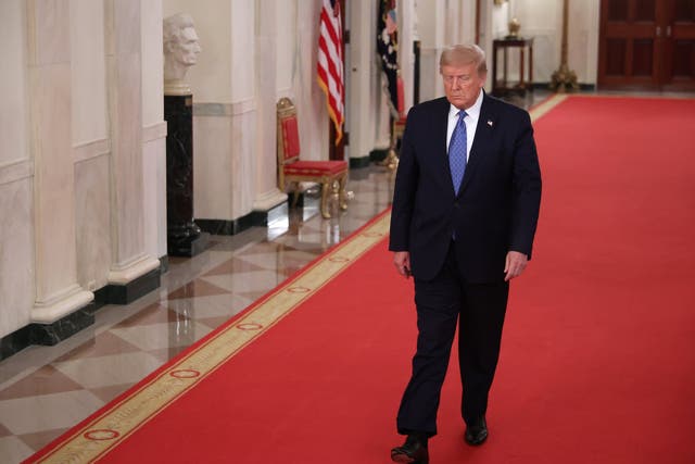 Donald Trump walks to the East Room to attend an event about 'Operation Legend: Combatting Violent Crime in American Cities' in the East Room of the White House