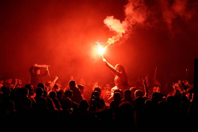 Liverpool fans celebrate outside Anfield as their side lift the Premier League trophy
