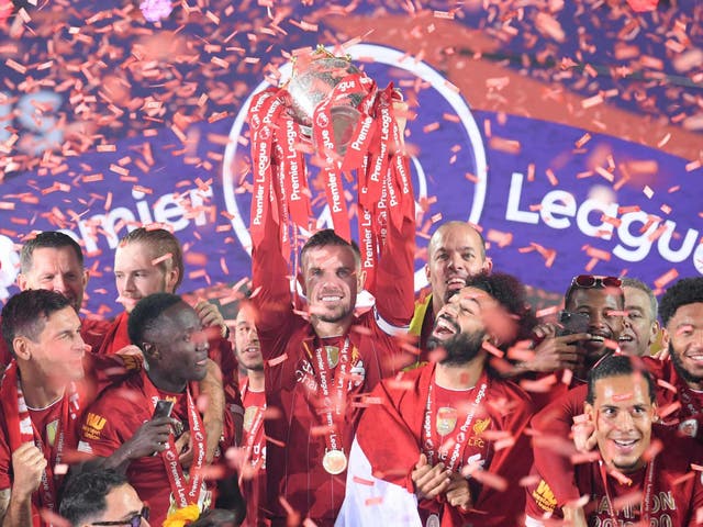 Jordan Henderson lifts the Premier League trophy after Liverpool's success