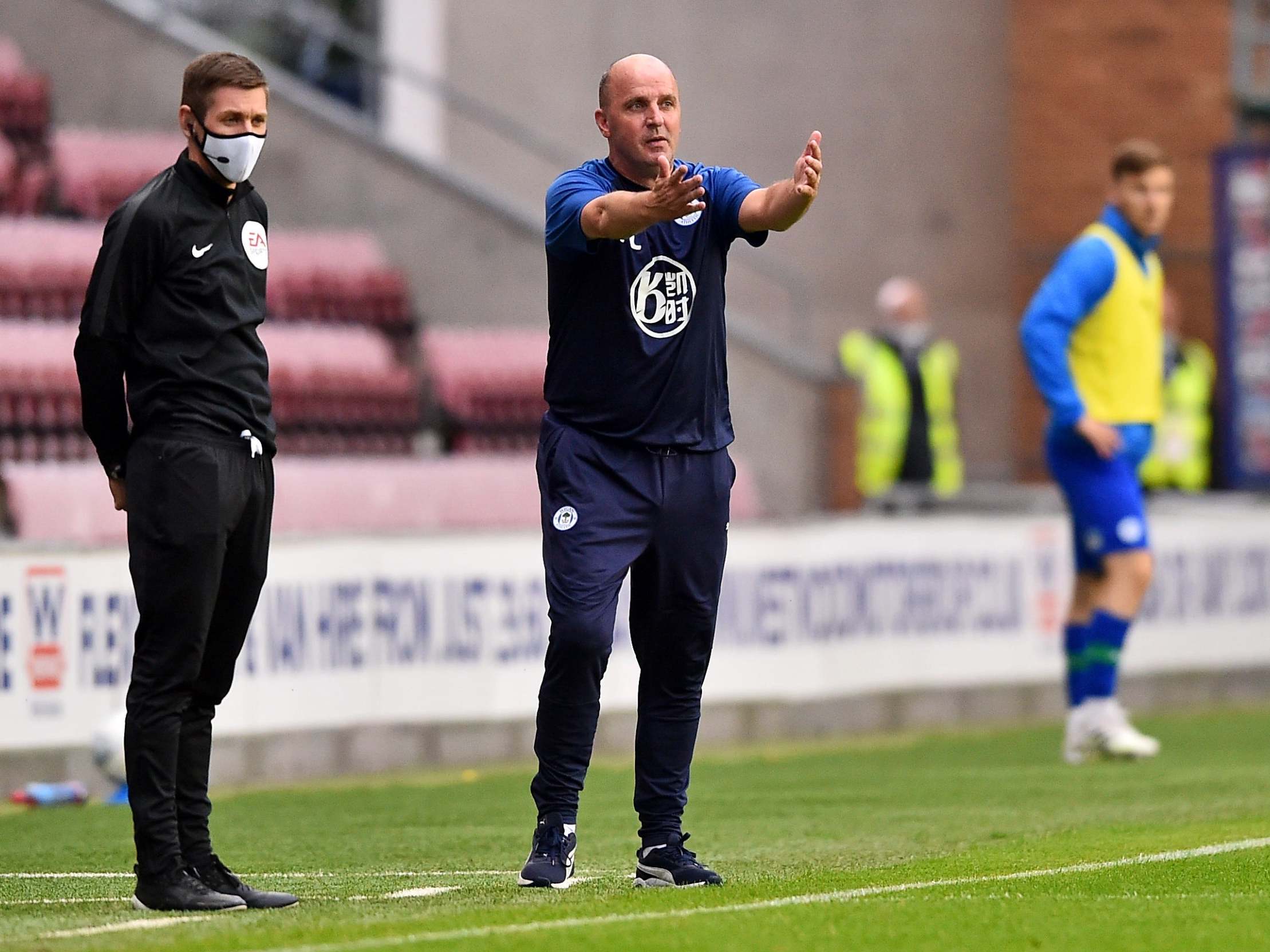 Wigan manager Paul Cook gestures during the draw with Fulham that could relegate the club to League One