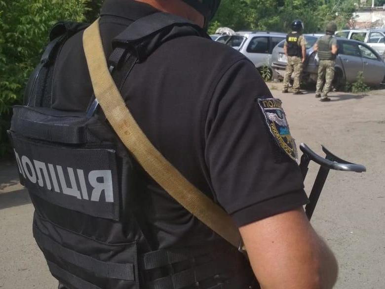 Ukrainian police officers near a site where the man held another officer hostage in Poltava