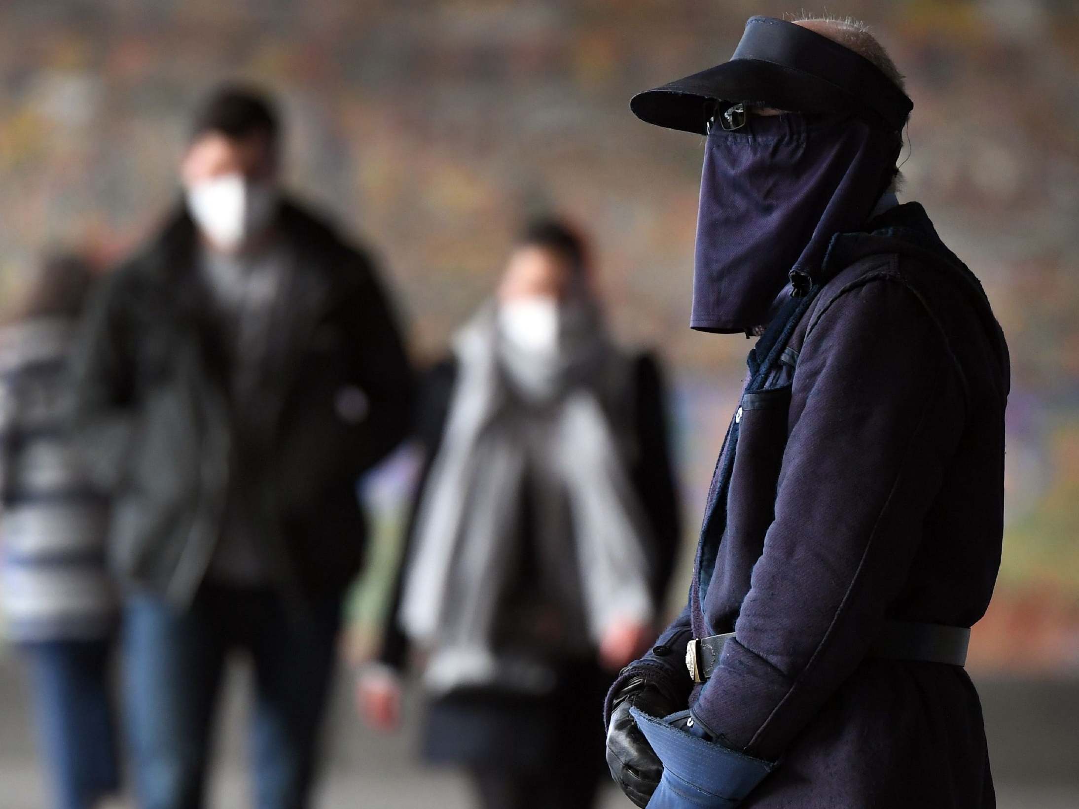 Commuters walk by Melbourne's Flinders Street Station as the wearing of face masks becomes mandatory