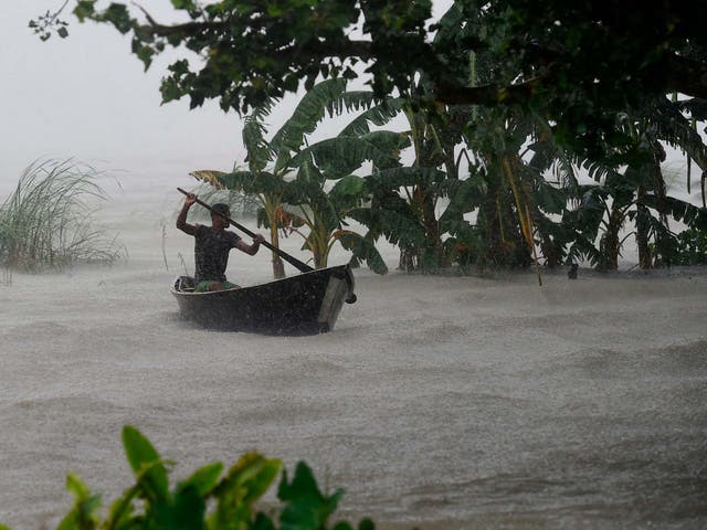 A man rows in flood waters in Dhaka, Bangladesh during the heavy monsoon rains this month. Extreme precipitation events are on the rise, driven by increasing temperatures