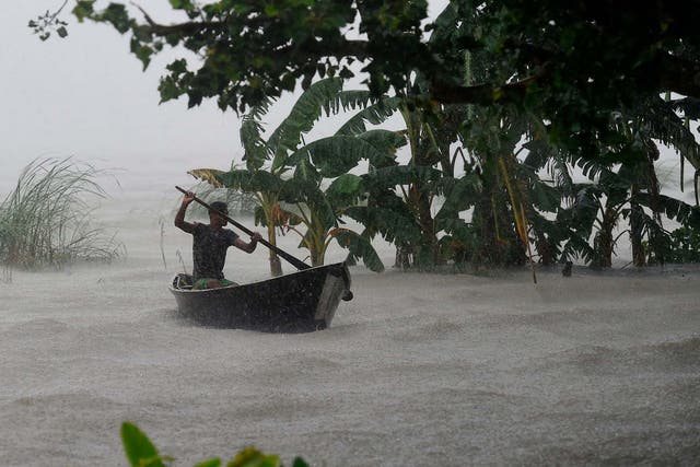 A man rows in flood waters in Dhaka, Bangladesh during the heavy monsoon rains this month. Extreme precipitation events are on the rise, driven by increasing temperatures