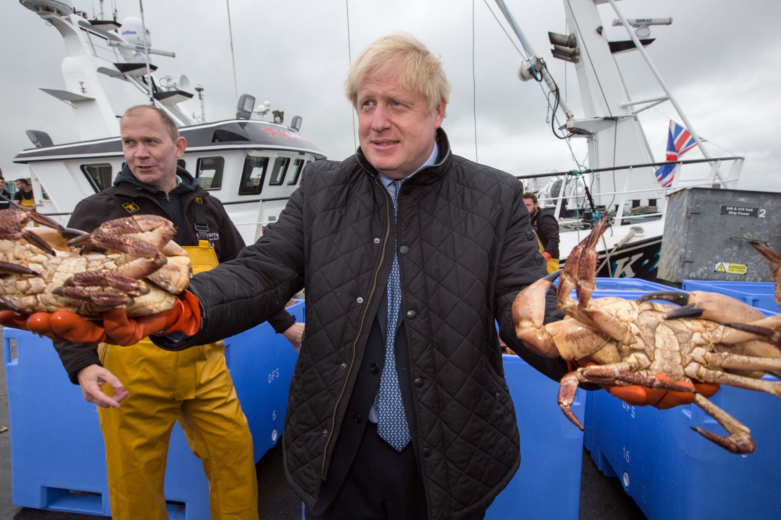 Boris Johnson holds crabs caught on the Carvela at Stromness Harbour during a visit to the Highlands and Northern Isles of Scotland