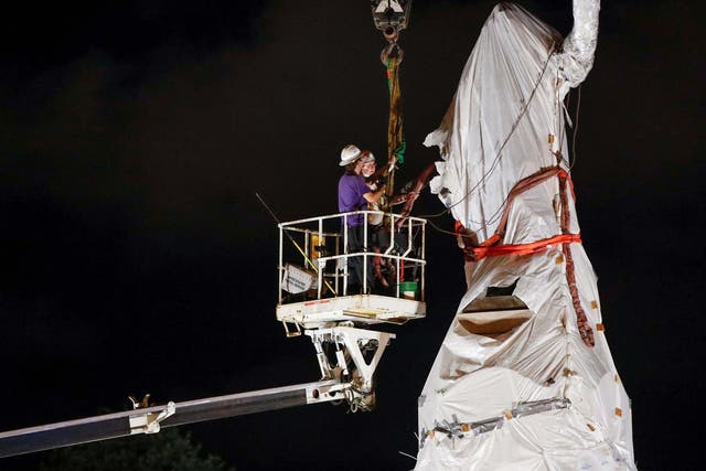 Crew members remove Christopher Columbus statue from the Grant Park in Chicago