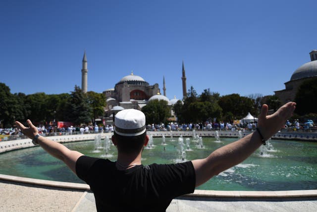 A man raises his arms in celebration as people gathered on Friday to attend the first prayers at the Hagia Sophia in Istanbul for almost 90 years