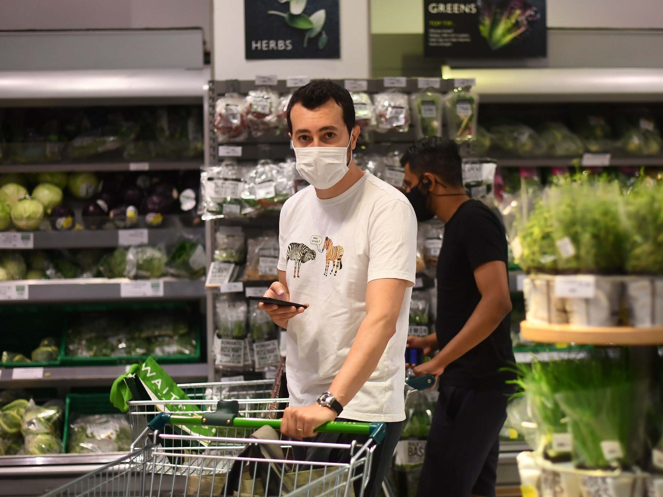 A shopper wearing a face mask in a supermarket in east London as face coverings become mandatory in shops and supermarkets in England, 24 July 2020.