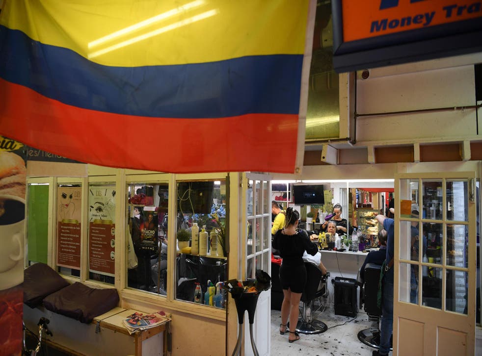 A Colombian flag is seen next to a hairdressing shop at the Seven Sisters indoors market in north London